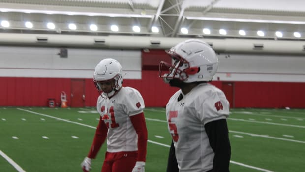 Cedrick Dort (No. 5) and Avyonne Jones (No. 21) hustle back after a special team's drill.